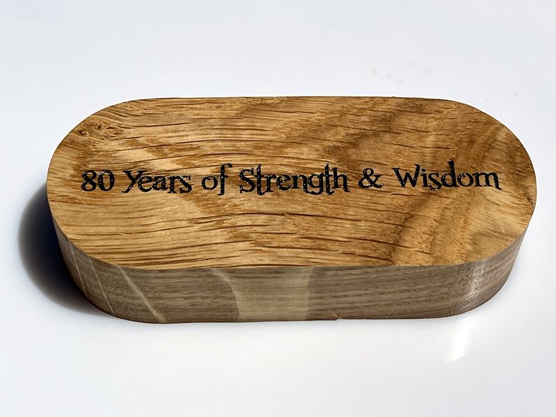 Laser-engraved back of an oak ring holder