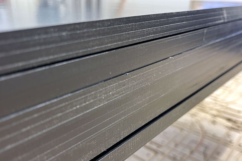 Black HDPE close-up: clean 82° chamfers and 45° V-cuts