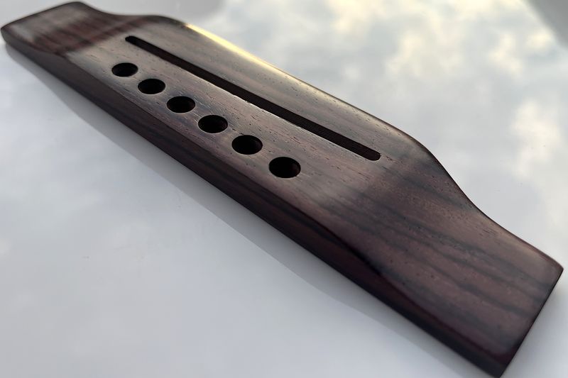 A rosewood bridge reflecting the clouds