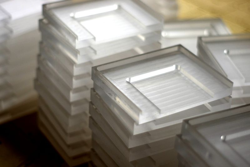 Stacks of thin plastic parts from a big production run, the kind of laser work we want more of
